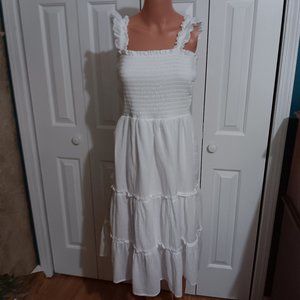 A BEAUTIFUL WHITE SUMMER DRESS MAKER IS  LUXOLOGY